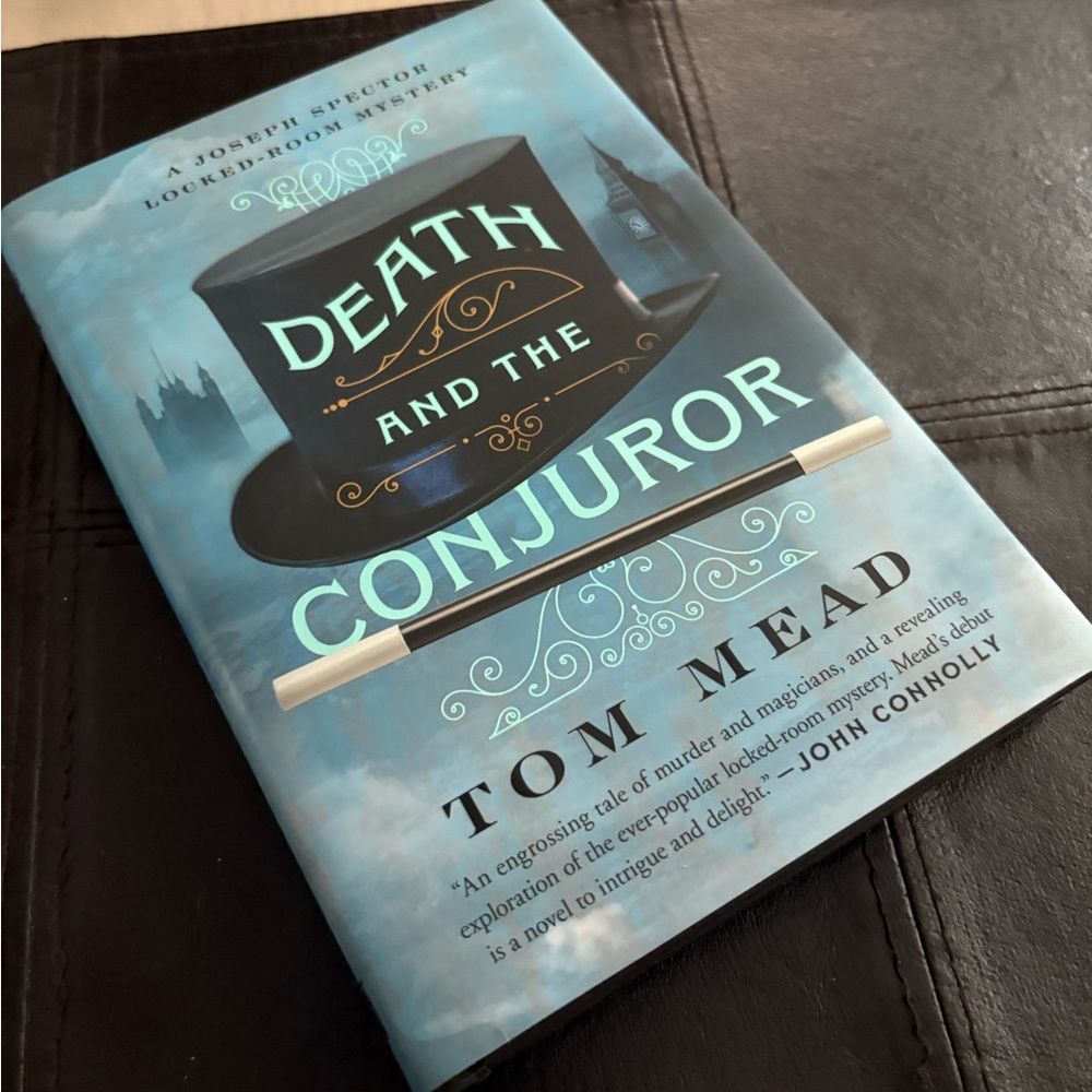 'Death and the Conjuror' Hardcover Book - Black and Blue Cover